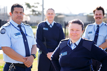 Two female and Two male prison officers standing outside.