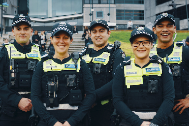 A line of five male and female police officers