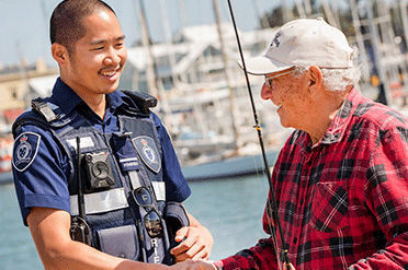 A fisheries Officer shaking hands with a fisherman