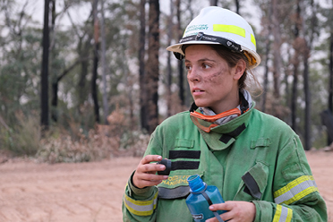 Become a forest firefighter, Woman pictured in firefighter equipment drinking water.